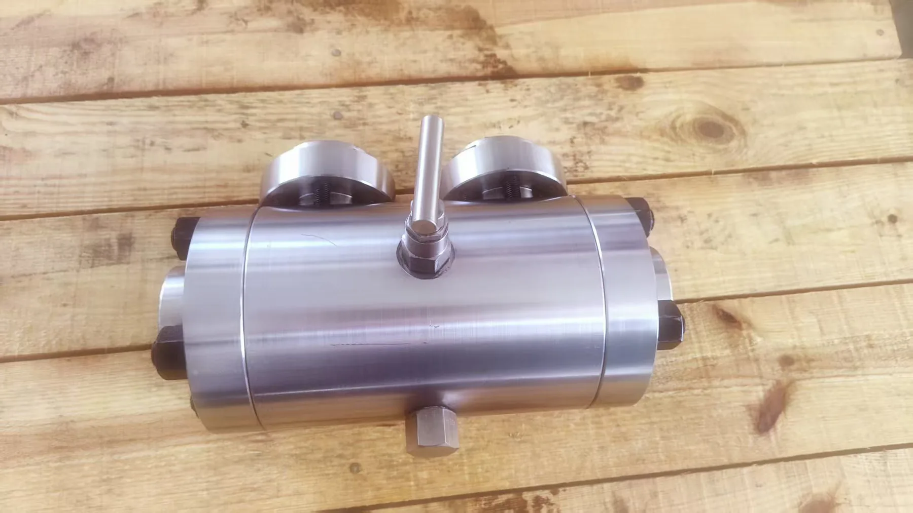 Compact integral valve body photographed in the workshop.
